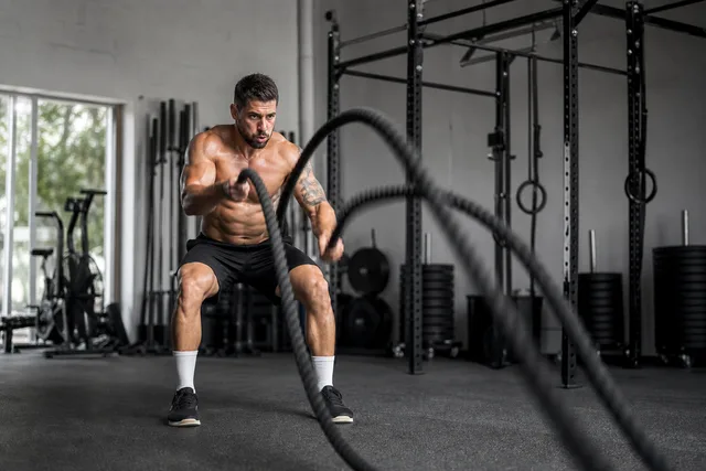 A man slamming battle ropes